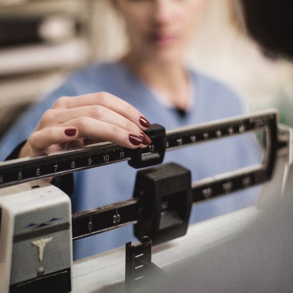 A person standing on a medical scale